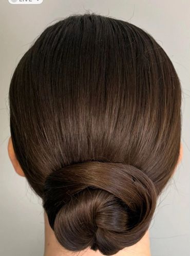 Sleek low bun hairstyle from the back.