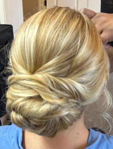 Blonde hair styled into an elegant updo.