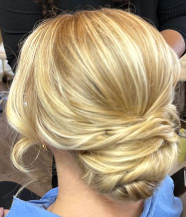 Elegant blonde updo hairstyle with soft curls.