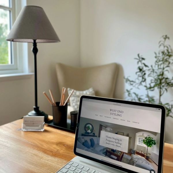 Home office desk with laptop displaying West End Styling website, used to represent Selling Point.
