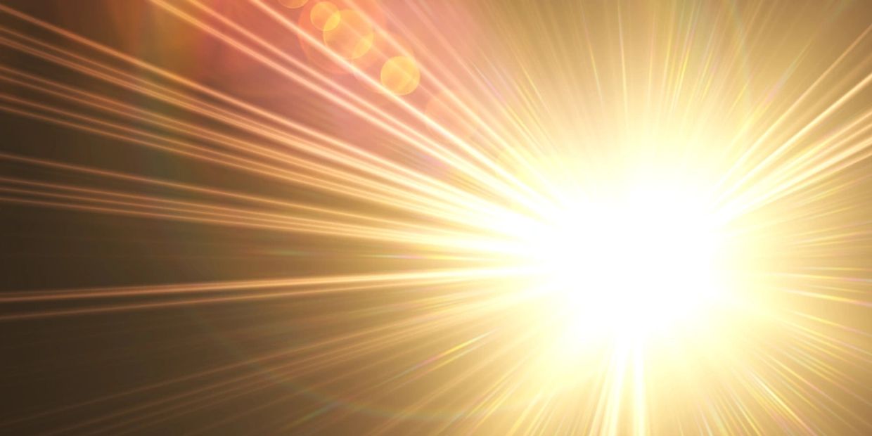 Close up burst of bright warm light. 