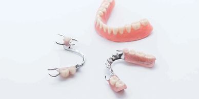Various dental prosthetics including dentures and partial plates.