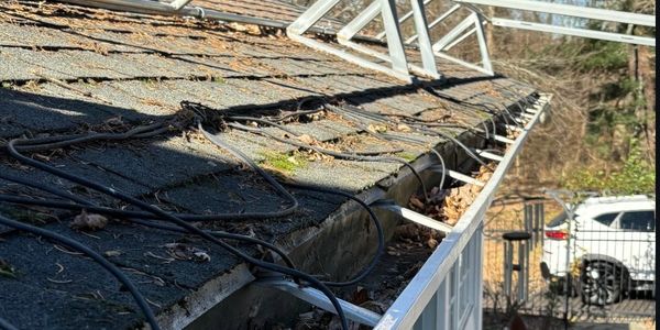 A rooftop with solar panel mounts and wiring in place.