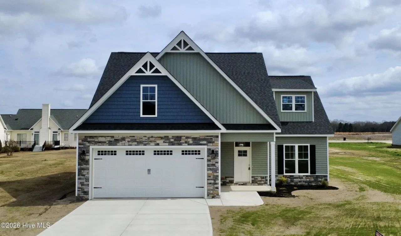 Modern single-family house with stone and siding exterior.