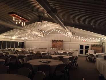 Inside wedding venue at night with lights.