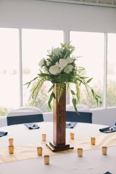 Tall table centerpiece inside of the wedding reception.