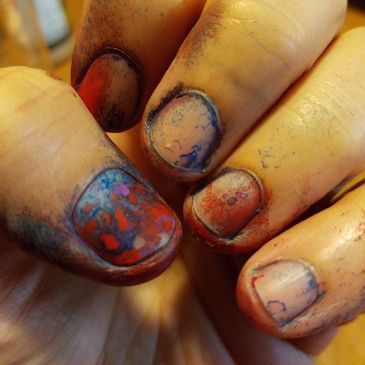 Jess's fingernails in a close up image showing them covered in paint. 