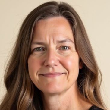 Portrait of a smiling woman with long brown hair.
