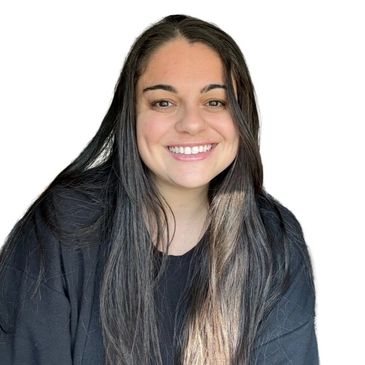 Smiling woman with long dark hair wearing a black top against a white background.