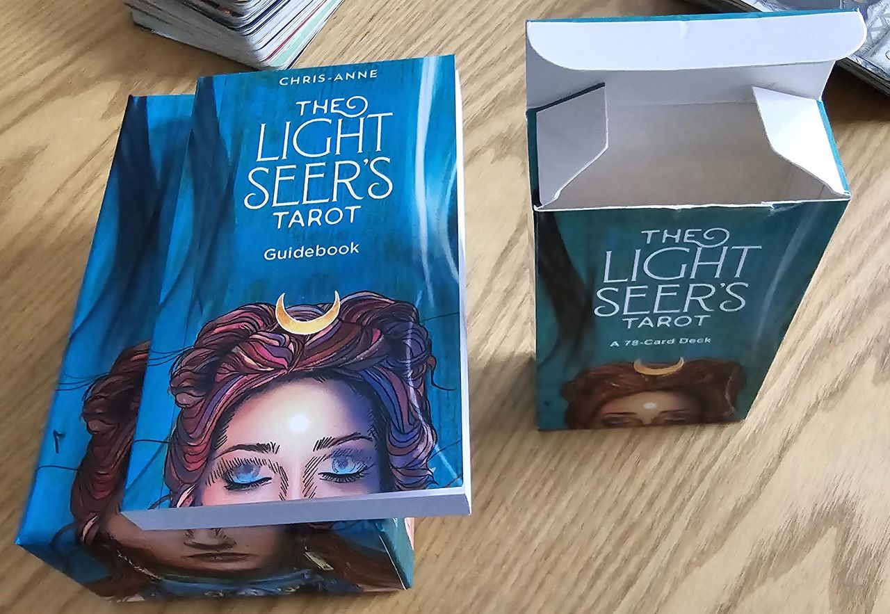 Authentic deck and guidebook on the left vs fake on the right.