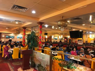 Guests sitting at their tables in dining room of Hop Woo.