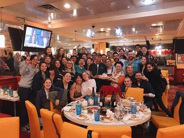 Group. of people smiling inside Hop Woo restaurant.