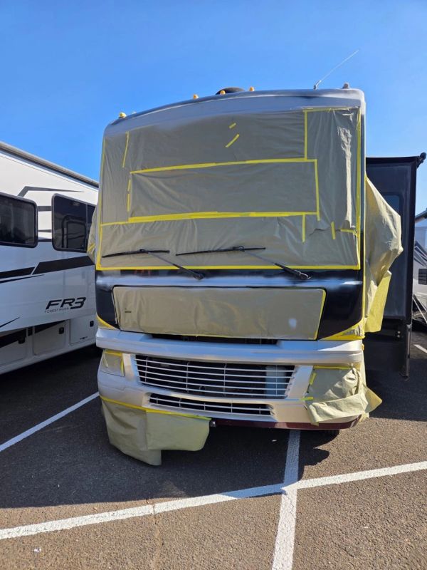 RV with front covered in protective masking paper.