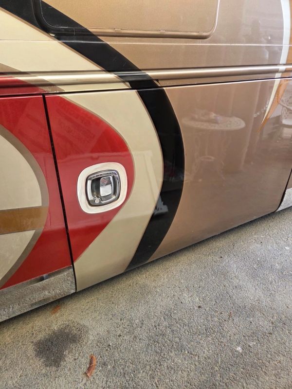 Close-up of a vehicle's side with colorful paint and a handle
