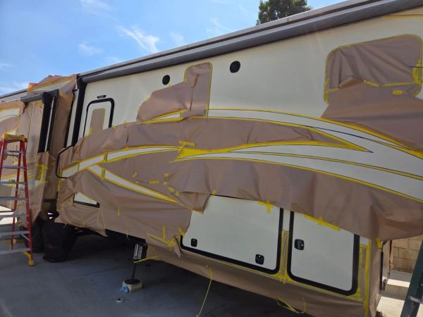 RV with masked areas for repainting.