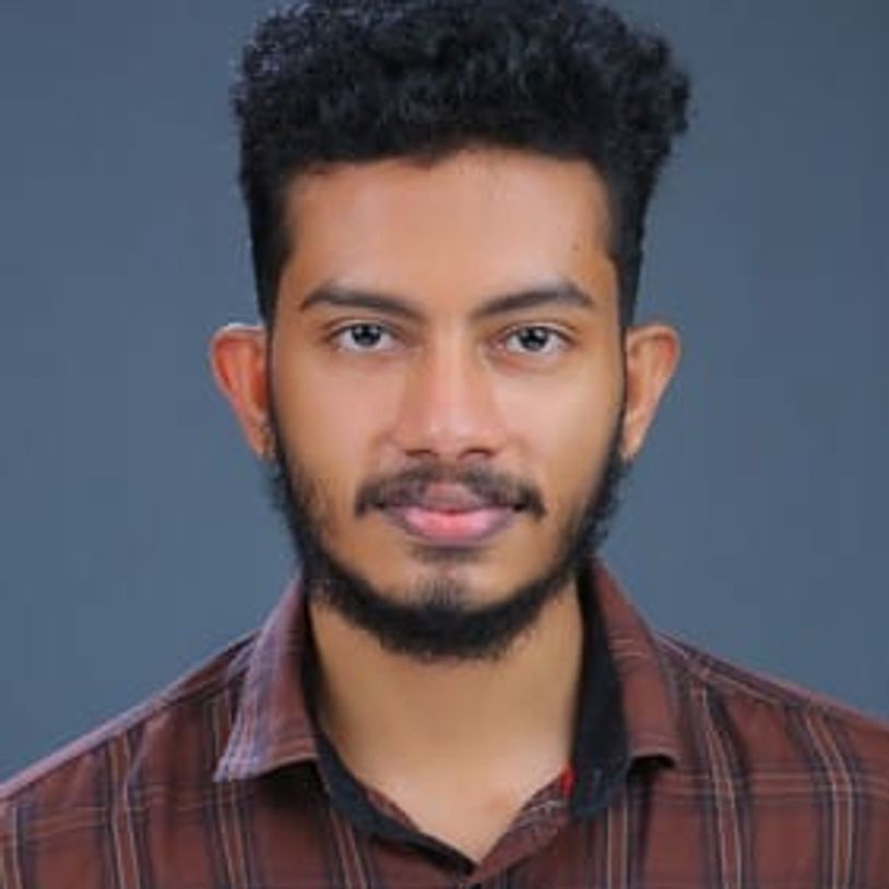 Young man with curly hair and beard.