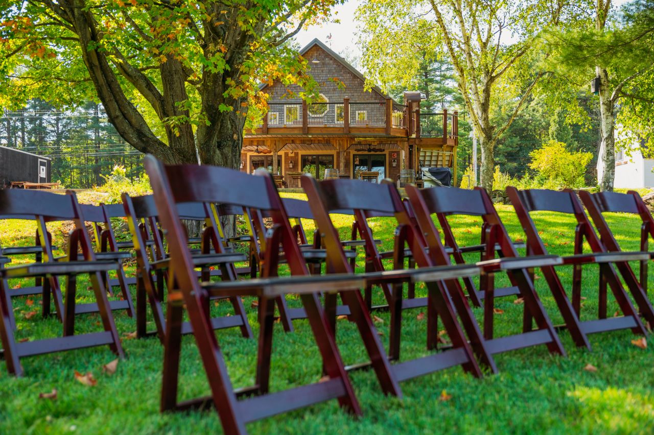 Oscar Barn rustic exterior with rows of chairs in Hooksett New Hampshire