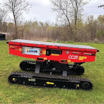Red tracked robotic vehicle labeled CC25 on grassy field.