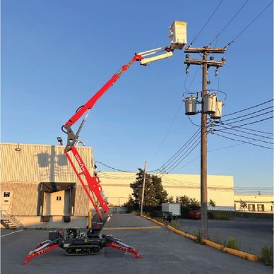 A red cherry picker lifts a worker near utility poles against a clear sky.