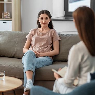 Young woman attentively listening during a therapy session.