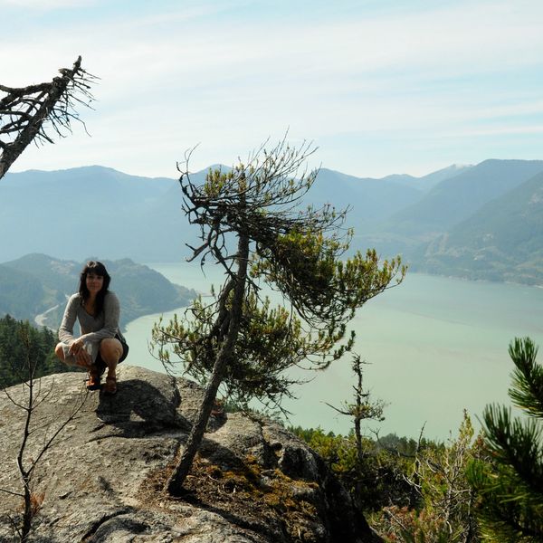 woman posing on a mountain top with beautiful view. How to have a healthy well balanced life