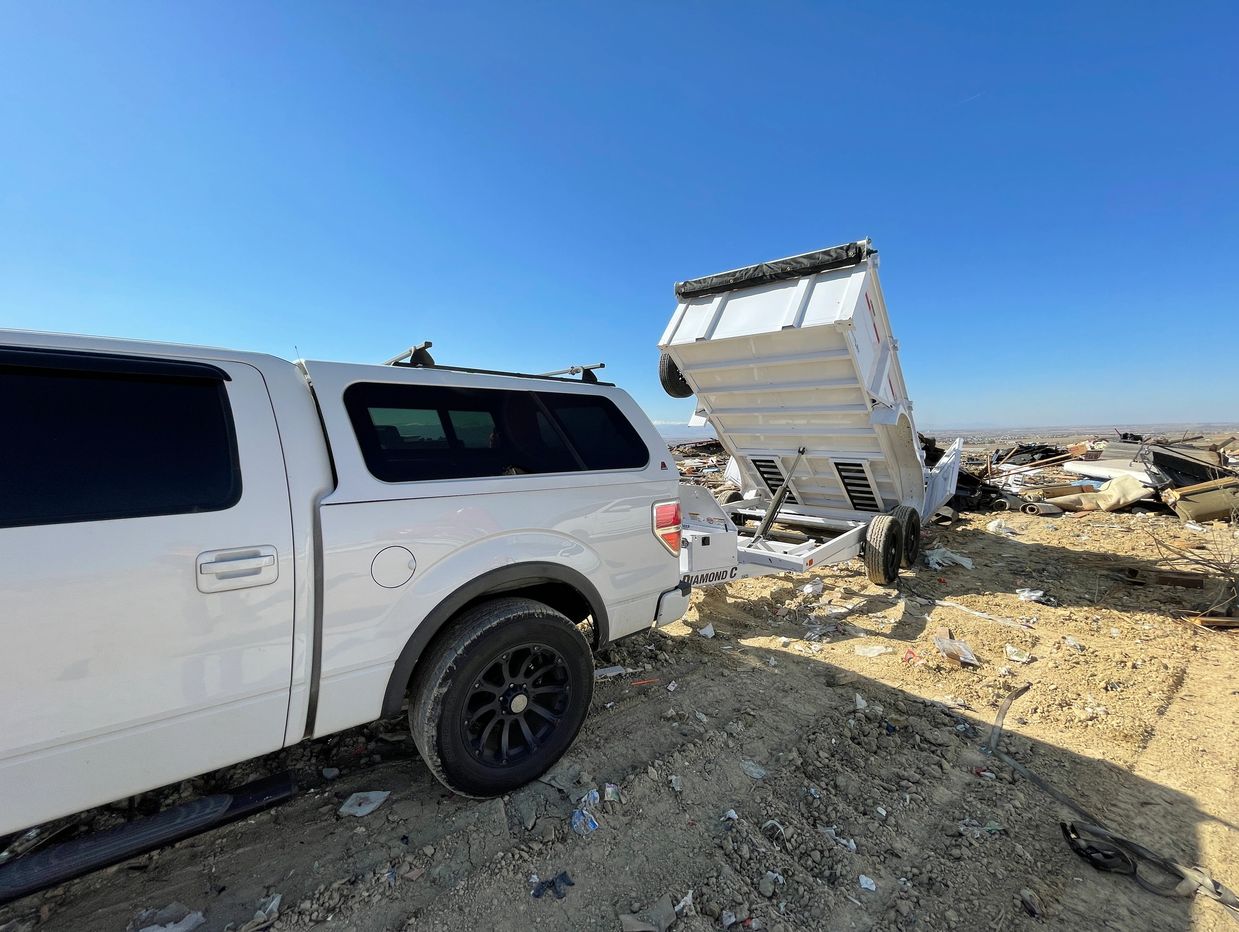 Dump Trailer Dumping Trash at Landfill