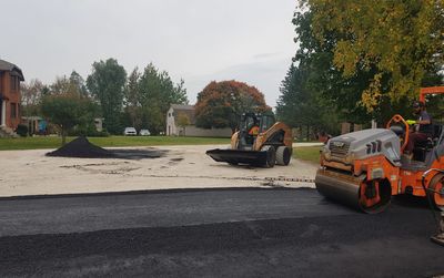 different paving machines working on a parking lot asphalt job 