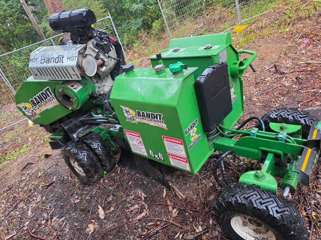 Bandit 2100SR stump grinder onsite before hydraulic pump coupling repair.
