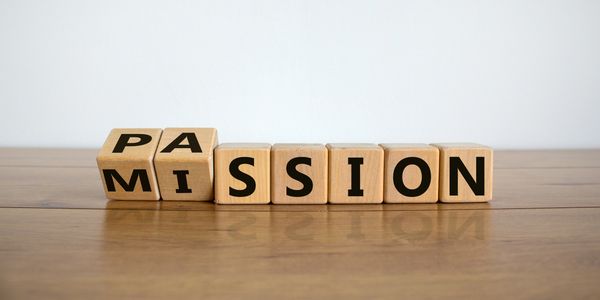Wooden blocks spelling 'PASSION' and 'MISSION'.