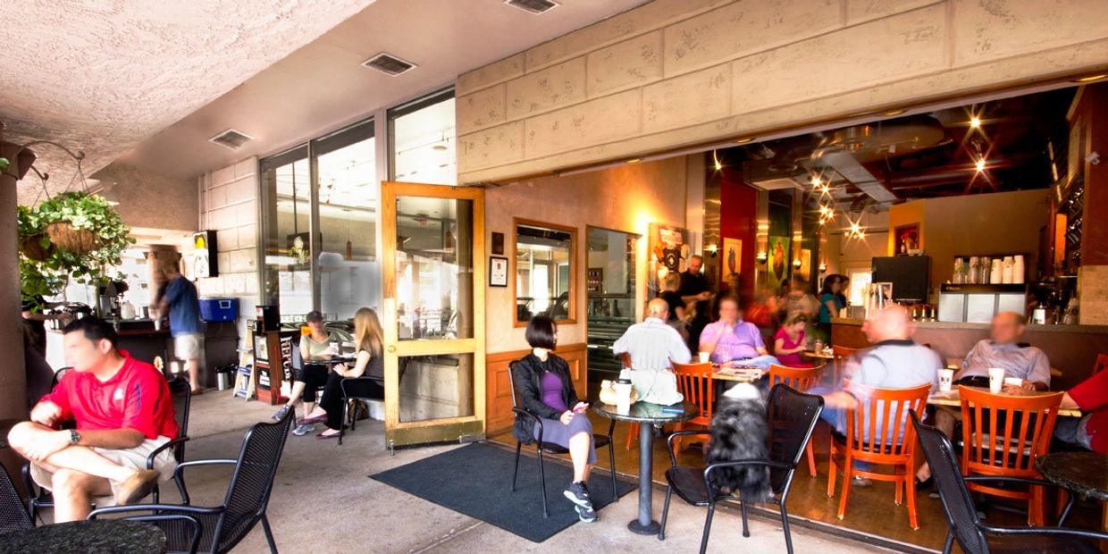 People on a patio drinking coffee and tea