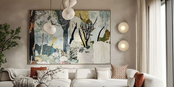 Modern living room with a large abstract painting and cozy white sofa.