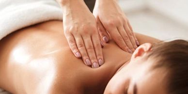 A woman getting massage by a person