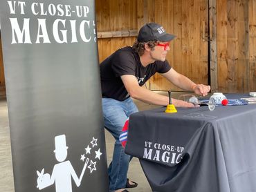 Magic station at a Farmer’s Market no longer with is. Bless the Isham farm. VT Close-Up Magic LLC 
