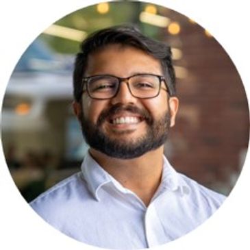 Smiling man with glasses and beard.