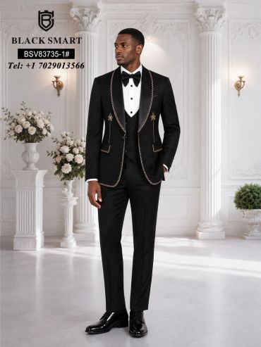 Man in a black embroidered tuxedo with bow tie.