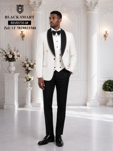 Man in a stylish white and black tuxedo in an elegant room.