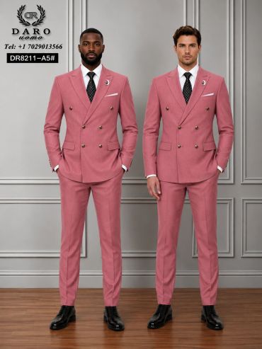 Two men in matching pink suits and black shoes standing side by side.