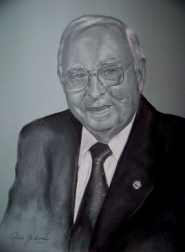 Monochrome portrait of an elderly man in suit and tie.