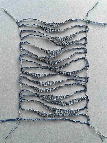 Machine embroidery resembling calm seas.