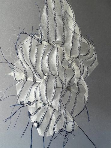 Stitched and manipulated fabric in a freeform shape.