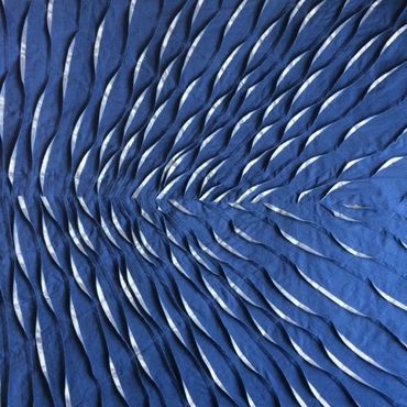 Pleated and tucked fabric in blue with silver applique textile artwork.