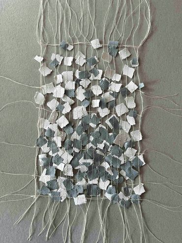 Machine stitched paper inspired by reflections in water.