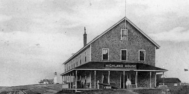 Historic black and white photo of Highland House near a lighthouse.