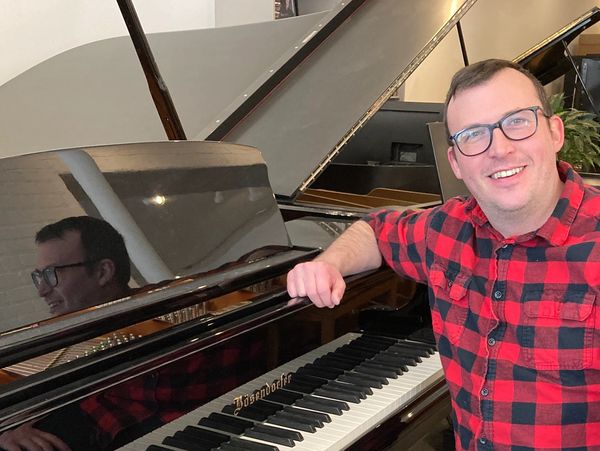 Lead Technician Victor Johnson with a Bosendorfer Grand