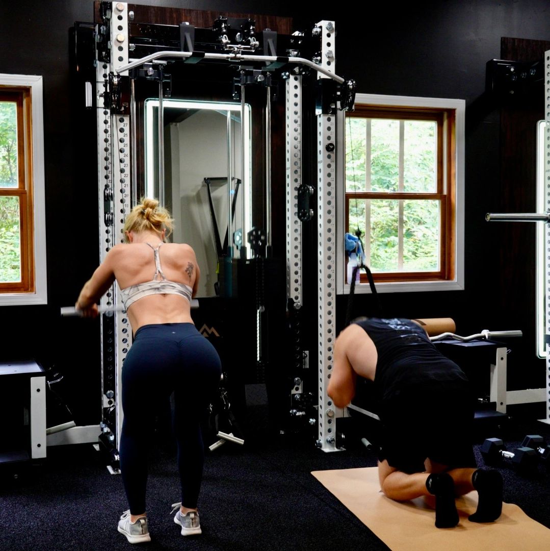 Two people working out in a gym.