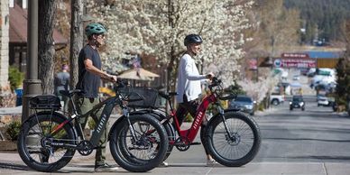 Aventon E-bikes being walked across street