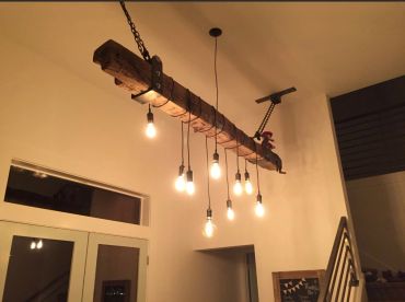 Rustic wooden chandelier with hanging bulbs.