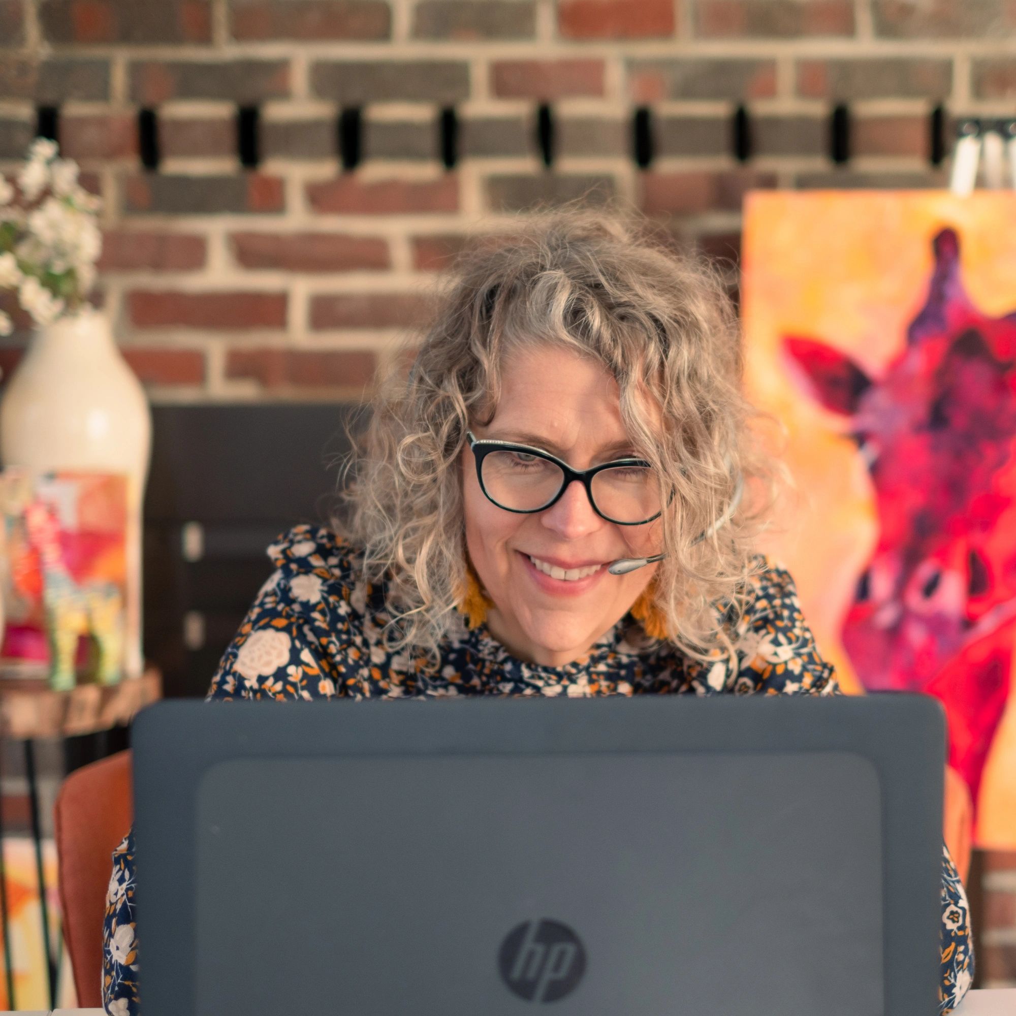 Jennessa Durrani on her computer sitting in her studio
