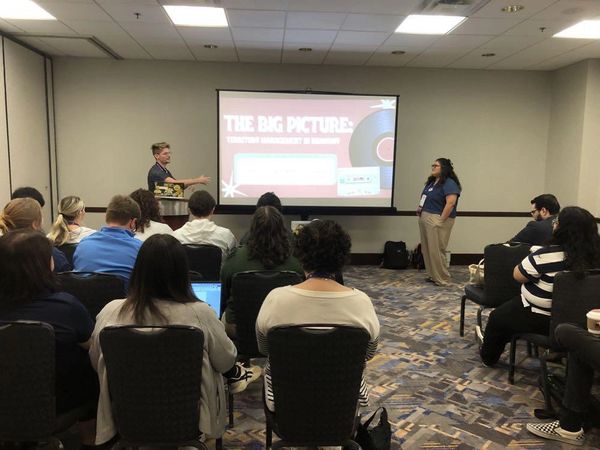Group attending a presentation on tourism management.
