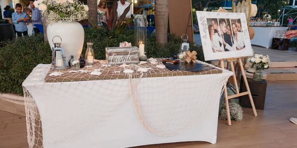 A decorated condolence table with flowers, candles, and a tribute photo board.